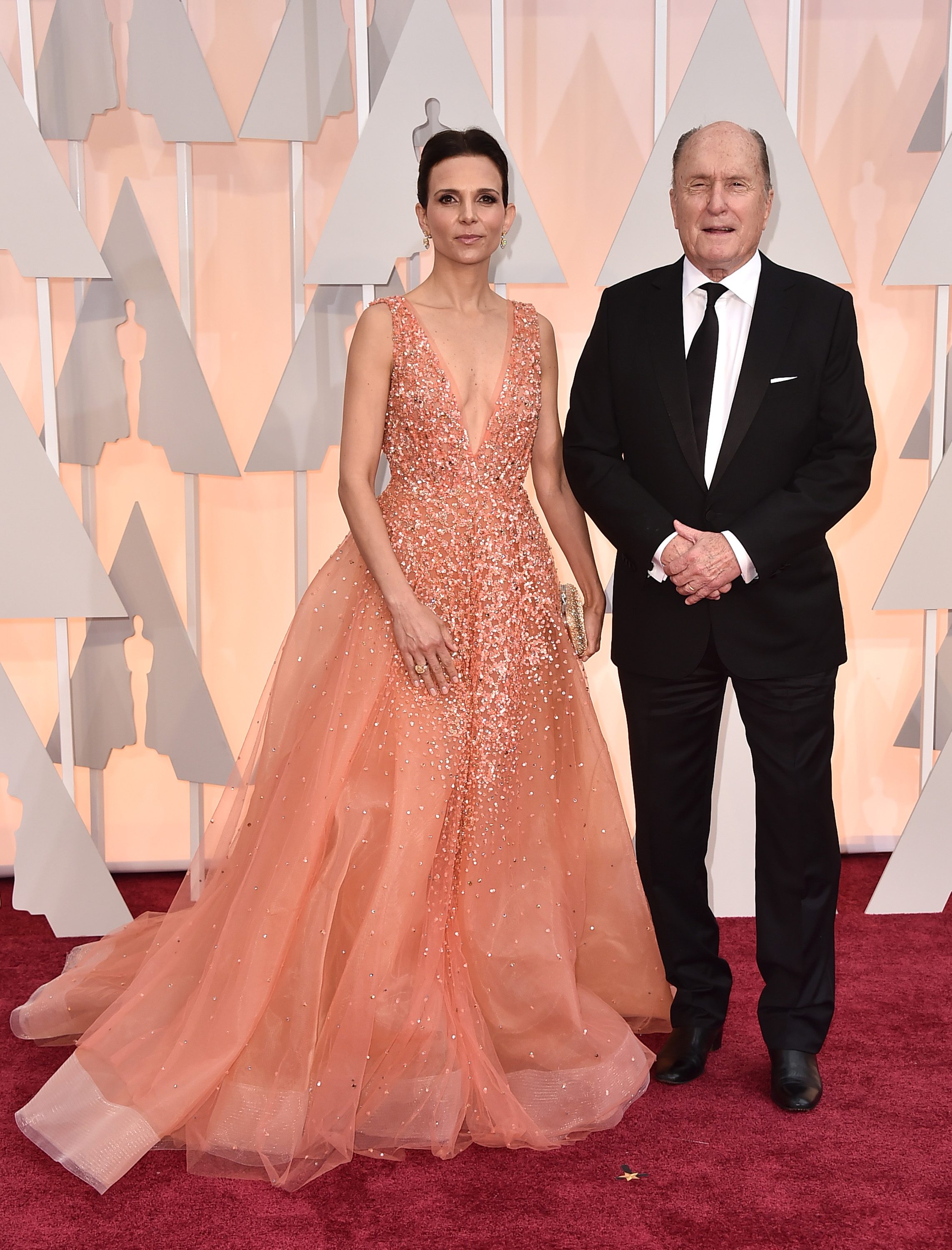 Luciana Duvall, left, and Robert Duvall arrive at the Oscars on Sunday, Feb. 22, 2015, at the Dolby Theatre in Los Angeles. (Photo by Jordan Strauss/Invision/AP)